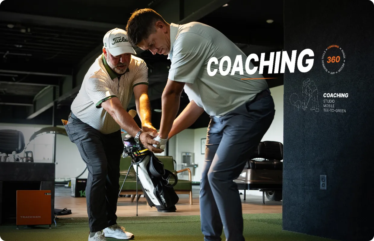 Golf coach guiding a student on swing technique indoors, with "Coaching" text and golf equipment in the background.