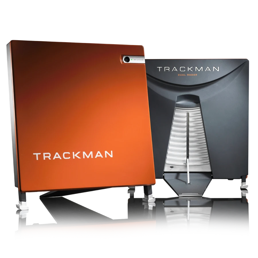Two TrackMan devices, one orange and one gray, featuring sleek designs with visible branding and metallic accents, used for sports analytics.
