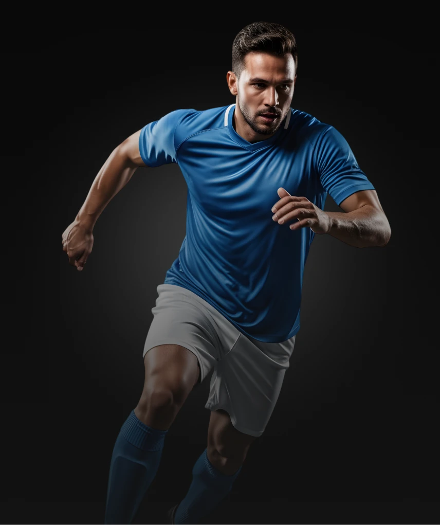A man in a blue jersey and white shorts is running with an intense expression against a dark background.